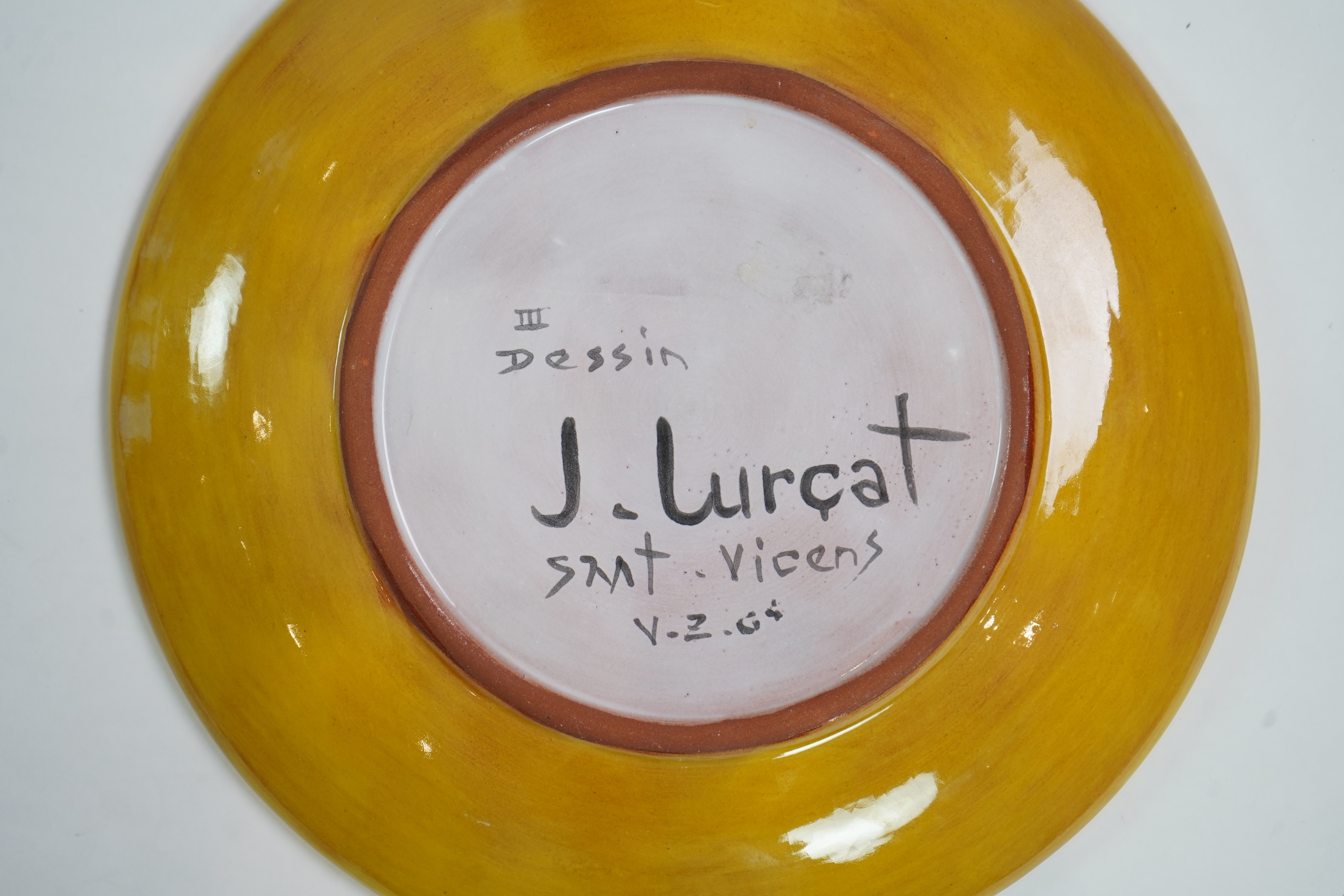 Jean Lurçat (1892-1966): A yellow glazed earthenware plate, decorated with a stylised central figure